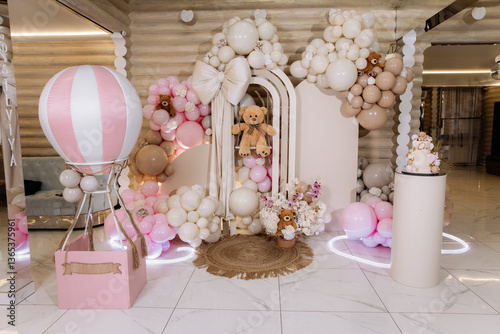 Photo zone in pastel tones, beige and pink balloons for a child's birthday celebration in a restaurant