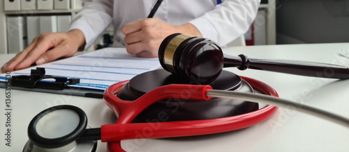 Obraz na plátne Judge gavel handcuffed doctor dealing with insurance paperwork in medical clinic