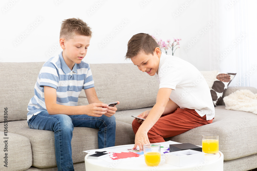Two kids playing card game spending quality leisure time at home. Two kids playing card game spending quality leisure time at home.