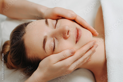 Wallpaper Mural face massage, young attractive caucasian woman, beautiful relaxed lady with closed eyes smiling, white towel, spa therapist doing facial and head massage in beauty salon, skincare and bodycare concept Torontodigital.ca