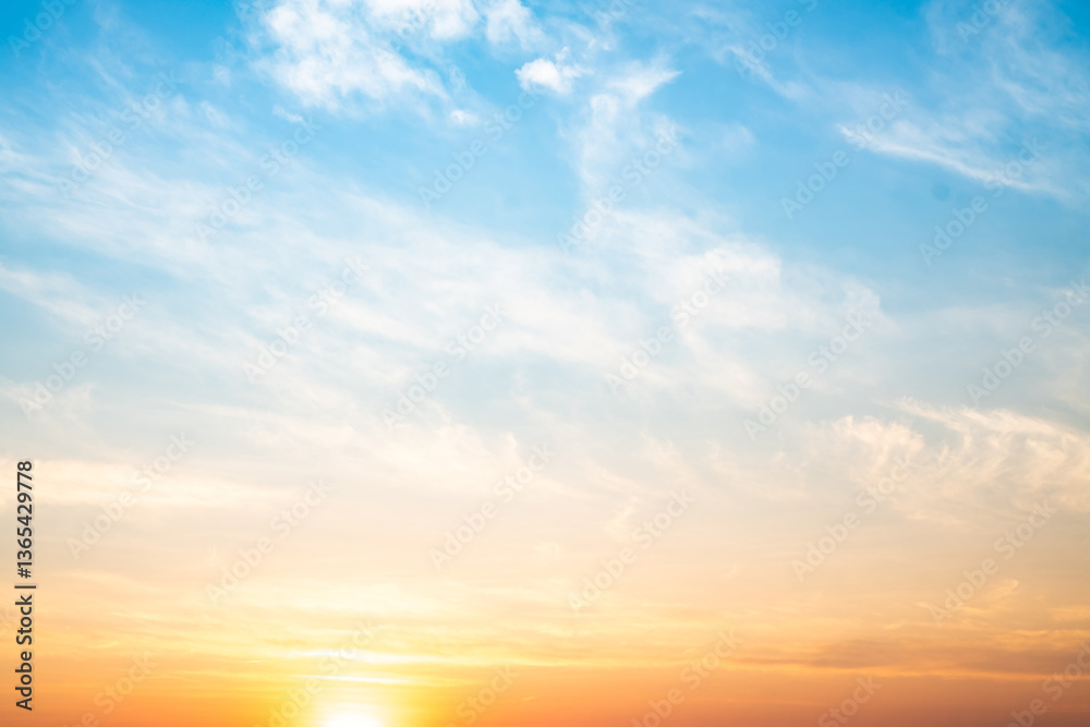 Obraz premium Beautiful , luxury soft gradient orange gold clouds and sunlight on the blue sky perfect for the background, take in evening,Twilight, Large size, high definition landscape photo