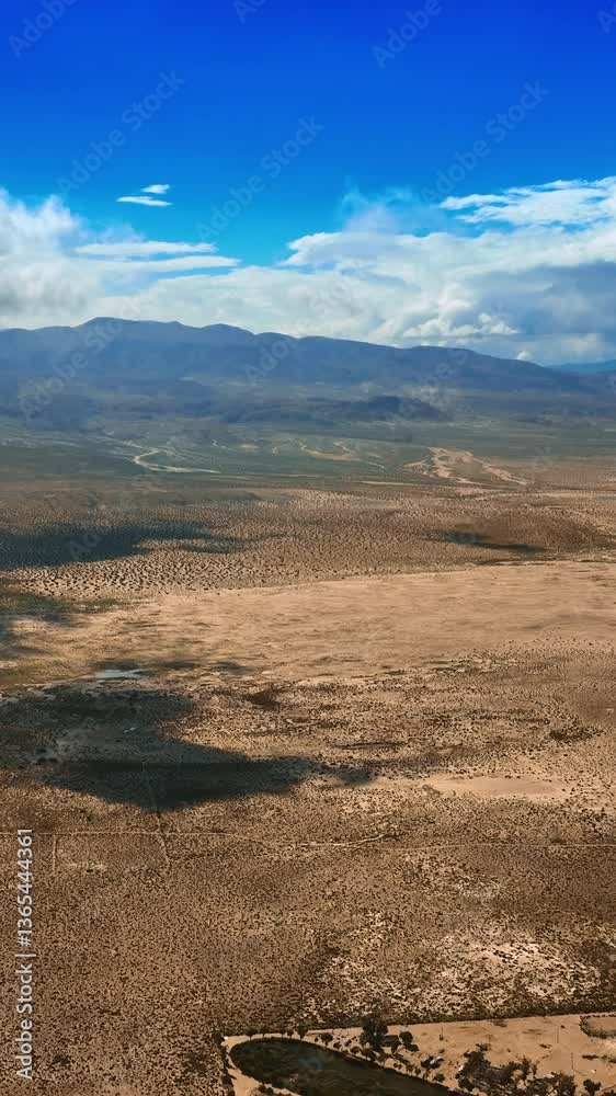 White cloudscape slowly floating in the air covering the desert from sun. Arid scenery of Death Valley from top view. Vertical video White cloudscape slowly floating in the air covering the desert from sun. Arid scenery of Death Valley from top view. Vertical video