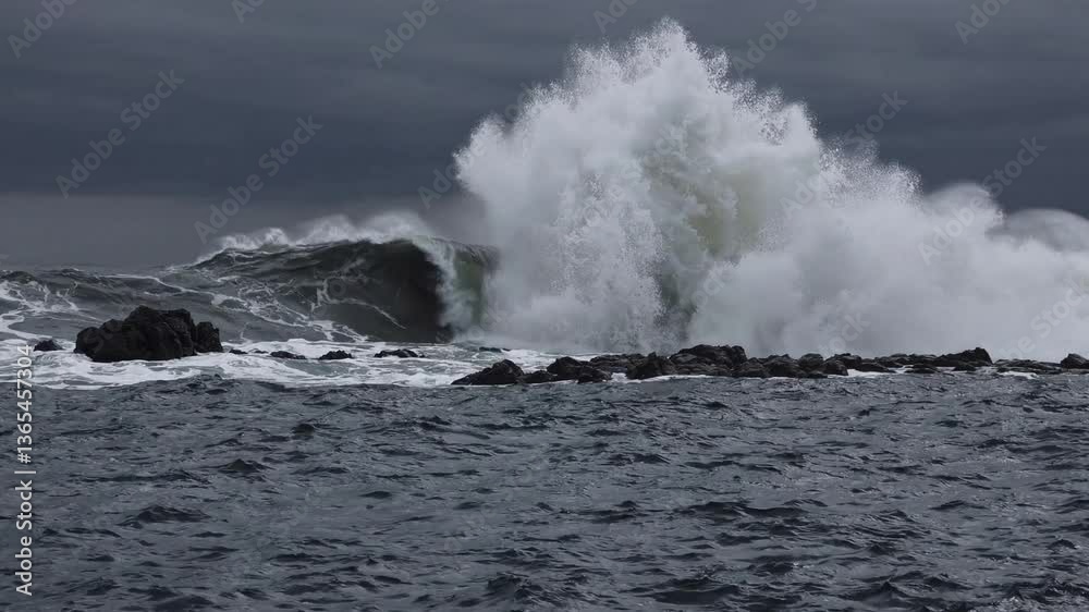 Dramatic ocean waves crashing on rocky coast sea wild blue grey foam Dramatic ocean waves crashing on rocky coast sea wild blue grey foam