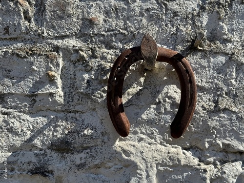 Rustic Horseshoe on an Old House Wall – Vintage Decoration