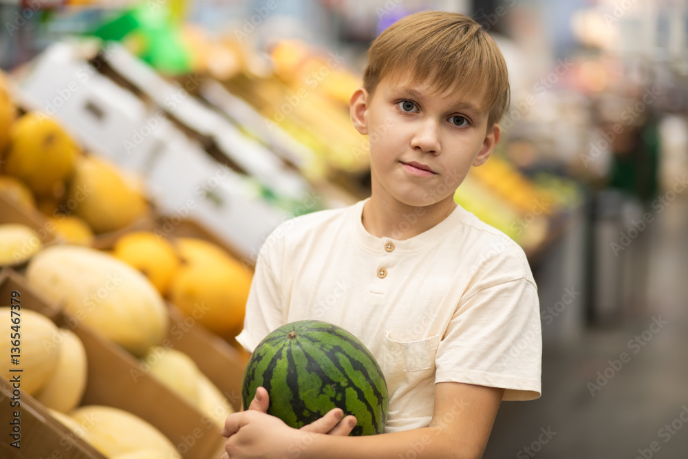 Fototapeta premium Kid teenager shopping for fresh organic fruits and vegetables in supermarket. Cute boy holding watermelon in a hands.