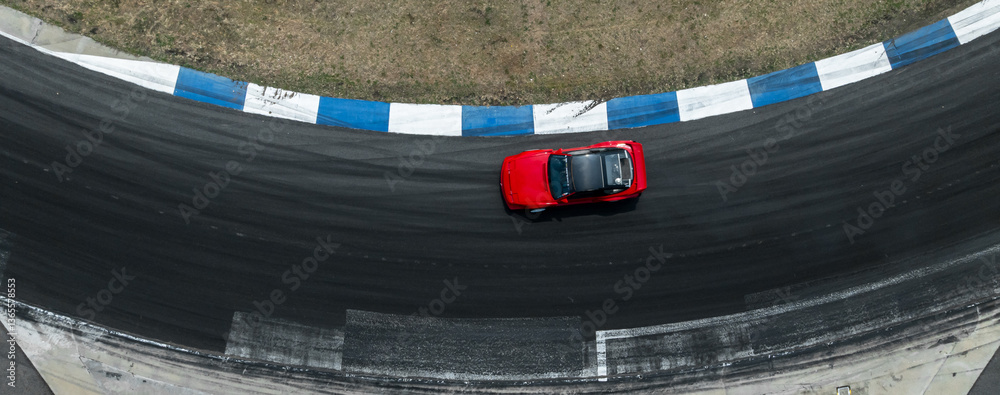 Top view car drift on asphalt race track with lot of smoke from burning tires rubber, Drift motor sport car drift race, Professional driver drift car on asphalt race track.