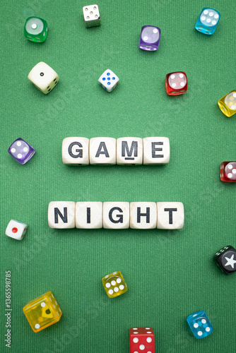 Fotografie Word dice showing the phrase 'Game Night', with a selection of colourful dice around it on a vibrant green baize fabric