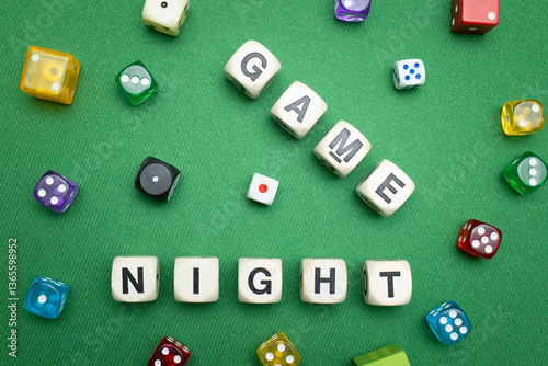 Fotografie Word dice showing the phrase 'Game Night', with a selection of colourful dice around it on a vibrant green baize fabric