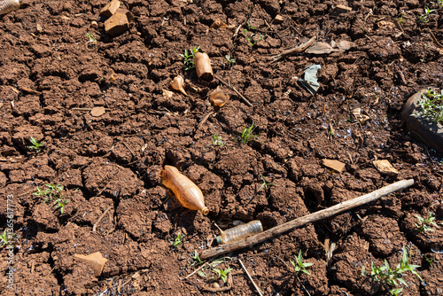 Crack in waterless pond, drying out. Waterless brown land with cracked soil in dry weather