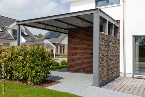 Moderner Carport mit Ablage für Kaminholz an einem Einfamilienhaus