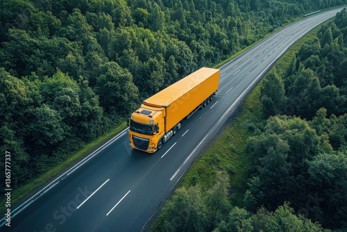 Yellow truck driving on tree-lined road.