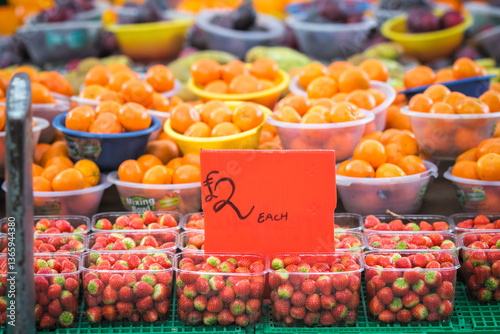 Strawberries and oranges displayed at a fruit stand in Walthamstow Market in London, England