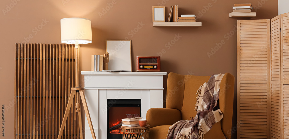 Naklejka premium Interior of living room with books, fireplace and armchair