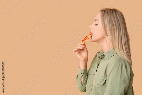 Young woman eating piece of...