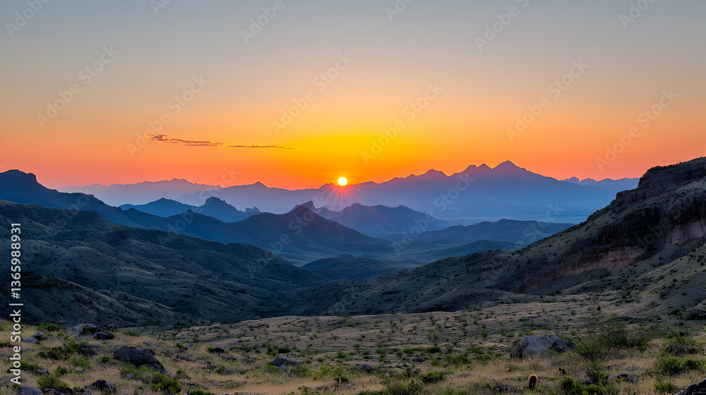 Obraz premium Sunset Over Mountain Range Revealing Silhouette Against Orange Sky Above Valley With Arid Terrain