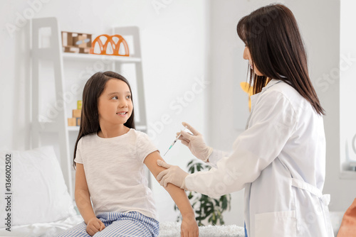 Little Asian girl receiving...
