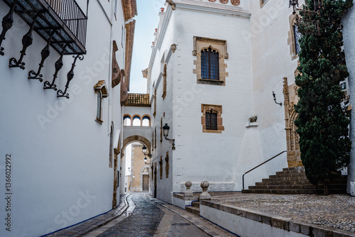 Fototapeta Naklejka Na Ścianę i Meble -  View of the a small street and alleys of Sitges, medieval Spanish town in the coast of Catalonia. Spanish architecture and tourism