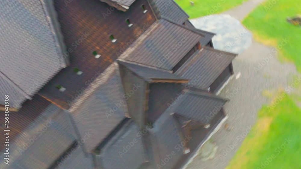 Old wooden church in Norway, aerial view with surrounding green field and cemetery