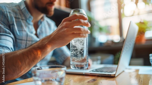 Person staying hydrated at work