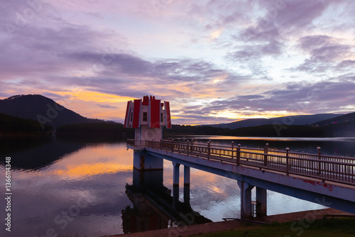 Wallpaper Mural A peaceful evening at Tuyen Lam Lake, Da Lat. The sunset casts golden and purple hues over the water. A bridge reflecting beautifully on the calm lake surface. Torontodigital.ca