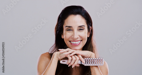Cosmetics, portrait and woman with hairbrush in studio for natural growth, scalp stimulation and grooming. Mockup, mature person and styling tool for volume hairstyle or beauty on white background photo