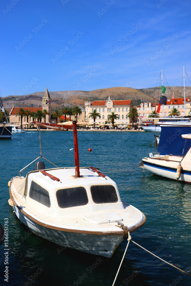 Beautiful old buildings, boats and yachts on the promenade in Trogir, Croatia. Sunny summer day in Trogir.