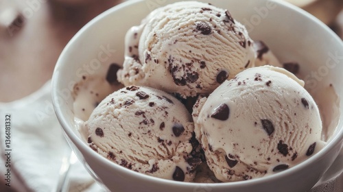 A delicious close-up of three scoops of vanilla ice cream topped with rich chocolate chunks in a white bowl. Ideal for advertising frozen treats, menu designs, and dessert promotions.. AI Generation