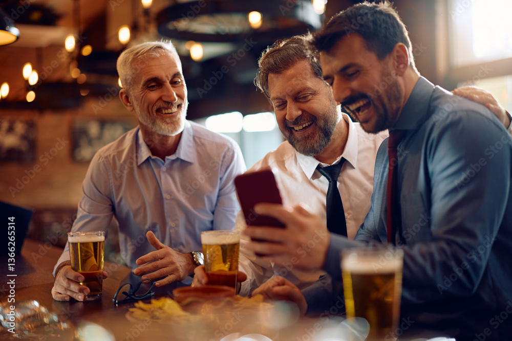 Cheerful businessmen using mobile phone while gathering for beer in bar. Cheerful businessmen using mobile phone while gathering for beer in bar.