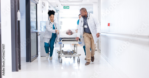 Running, hospital and doctors with bed for emergency, surgery and help for medical service. Healthcare, er and people rush with stretcher for accident, operation or surgical treatment in hallway