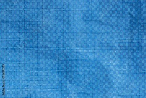 Blue industrial weatherproof tarpaulin sheet background backdrop. Industrial commercial heavy duty material