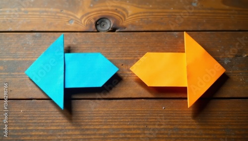 Two paper arrows pointing in opposing directions on a wooden table, path, design
