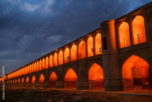 View of the Si-o-se-pol Bridge or Allahverdi Khan Bridge in the evening, Isfahan, Iran. The bridge was built in 1602. Nowadays, it is a popular tourist attraction in the city