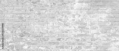 A brick wall as white background. The wall is covered in white paint and has a rough texture