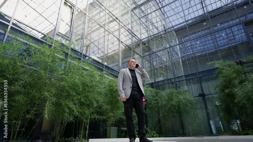 Businessman talking on the phone. Modern office atrium concept. Businessman talking on the phone. Modern office atrium concept.