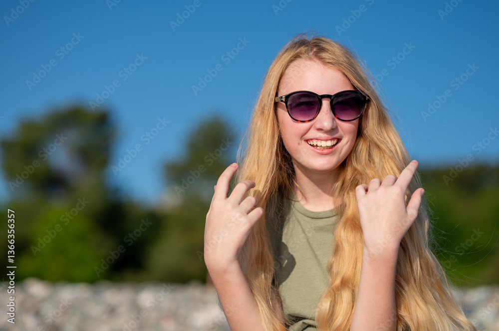 Smiling young woman with sunglasses under clear blue sky. Smiling young woman with sunglasses under clear blue sky.