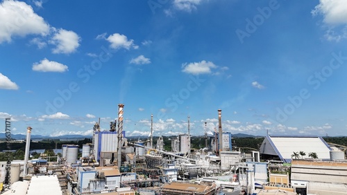 Pulp and paper industry with factory buildings and chimneys in operation during daylight