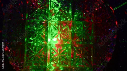 Intro for a rhythmic music video. Green and red lights through a crystal pattern.