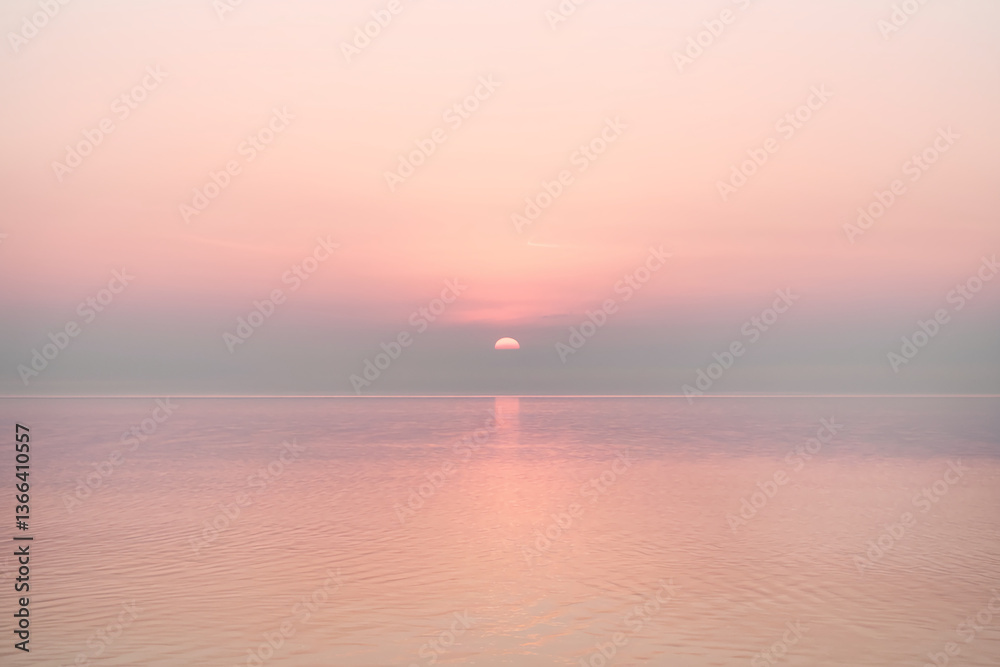 Obraz premium Pink sunset over calm water, reflecting soft light, creating a serene and peaceful atmosphere, ideal for tranquility or meditation concepts