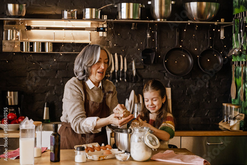 A White grandmother and granddaughter bake cookies in a cozy kitchen, mixing dough, shaping treats, and laughing together, surrounded by a warm light and some festive decor, creating holiday memories.