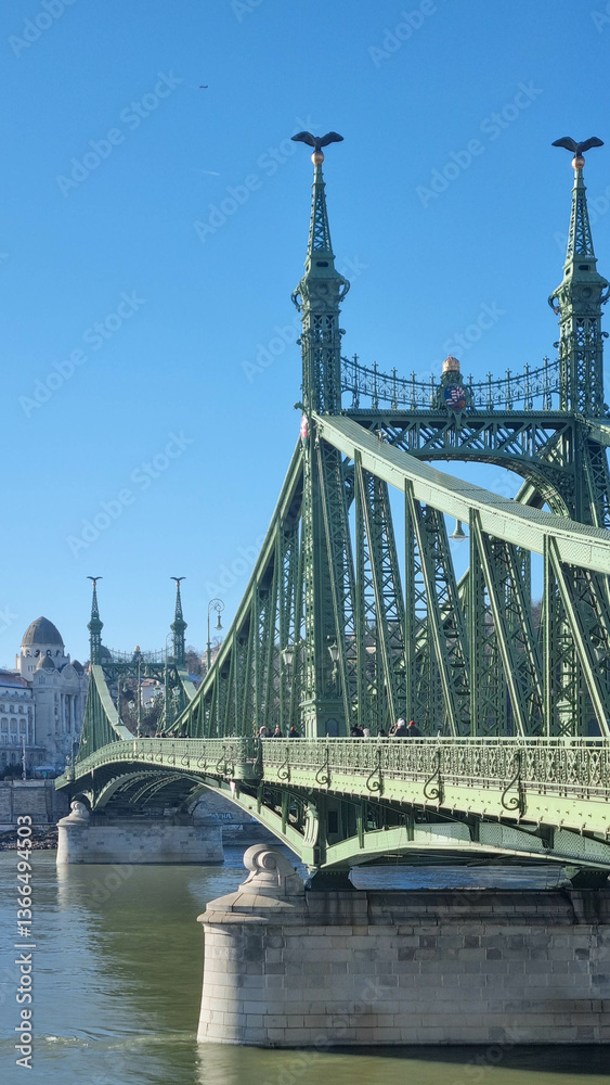 Fototapeta premium BUDAPEST, HUNGARY - January 2024: Panoramic view of the Liberty Bridge or Freedom Bridge as it is also known, which crosses the River Danube in Budapest