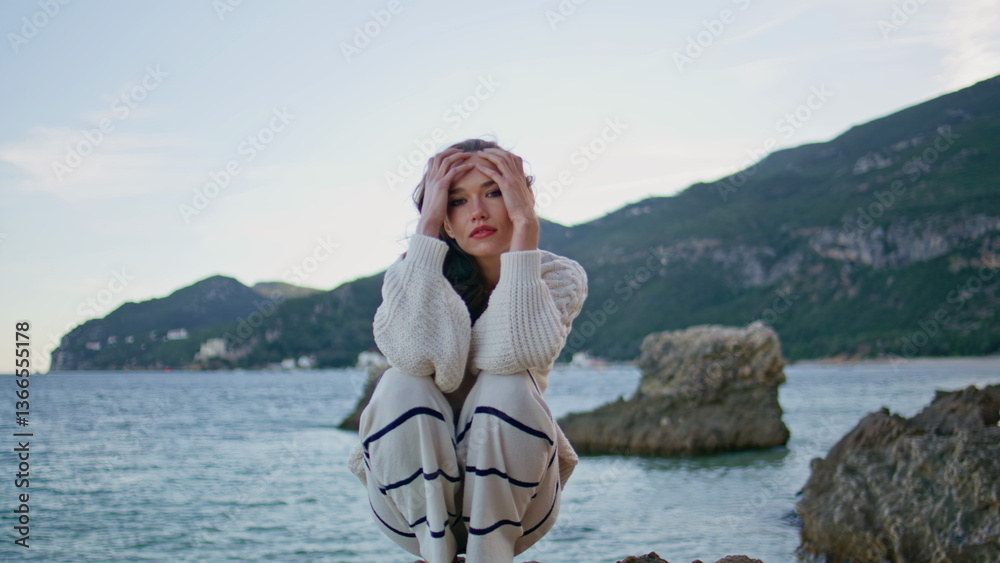 Fototapeta premium Calm tourist posing ocean coastal rocks at twilight closeup. Model relaxing