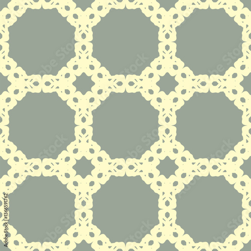 Seamless pattern with repeating geometric shapes. Light yellow lace-like motifs on a gray background. Symmetrical design featuring octagonal and floral elements. Elegant and stylized artistic motifs.