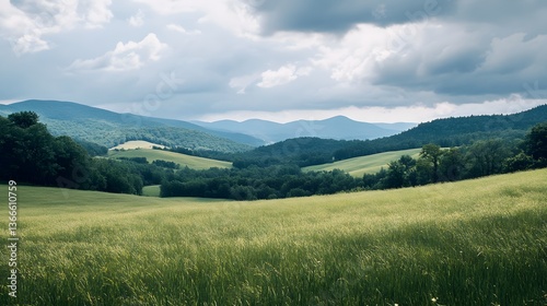 Expansive green hills stretch beneath a moody sky in the mountains during a tranquil afternoon in the countryside