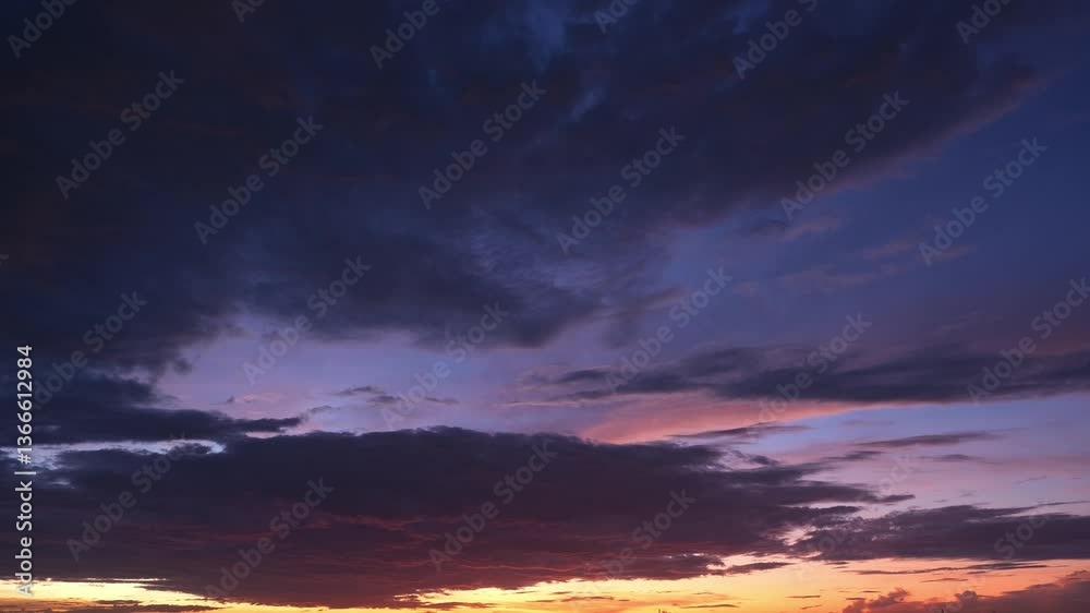 4K: A time lapse video captures the sky at sunrise, where clouds drift seamlessly. Atmospheric circulation concept. Stock footage.
