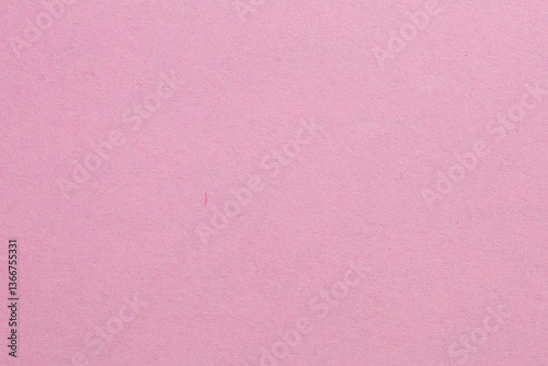 A pink background with a white object in the middle, textured origami paper backdrop