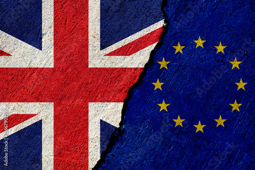 cracked concrete wall with painted united kingdom and european union national flags, economical or political relations concept