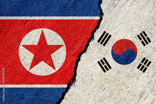 cracked concrete wall with painted north korea and south korea national flags, economical or political conflict concept
