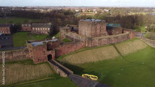 Aerial cinematic of front gate and facade of 11th Century Carlisle Castle - Cumbria, England photo