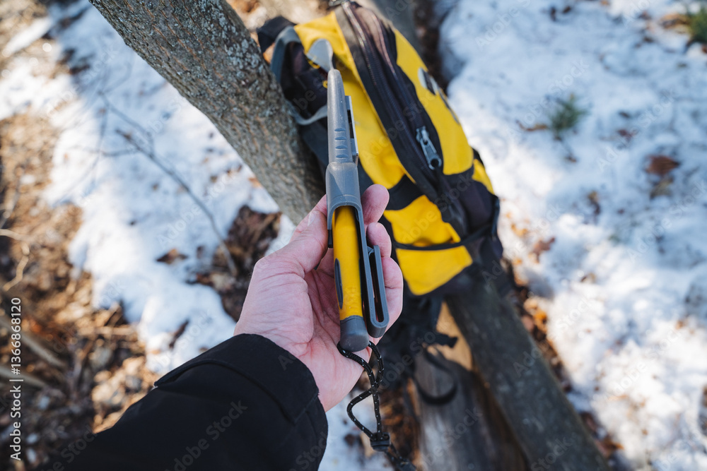 A person is firmly holding a bright yellow and sleek black tool in their hand, showcasing its importance and utility for various activities or tasks they might be involved in A person is firmly holding a bright yellow and sleek black tool in their hand, showcasing its importance and utility for various activities or tasks they might be involved in