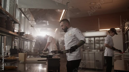 Man chef cooking dishes in restaurant kitchen